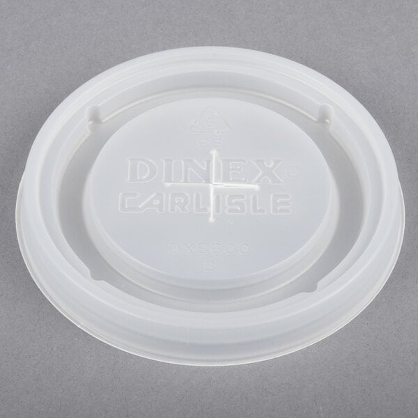 A white plastic lid with the word "Dinex" and a cross on it.