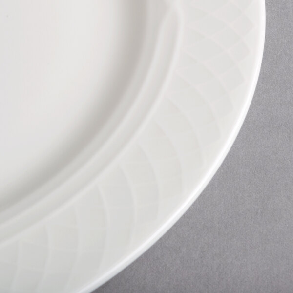 A close-up of a Homer Laughlin Kensington Ameriwhite bright white china plate with a circular design.