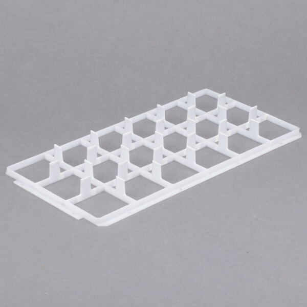 A white plastic grid with rows of hexagons.