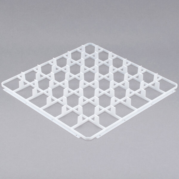 A white plastic grid with a grid pattern that fits into a square glass rack.