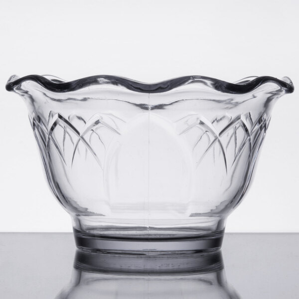 A clear Dinex Fenwick cup with a scalloped edge.