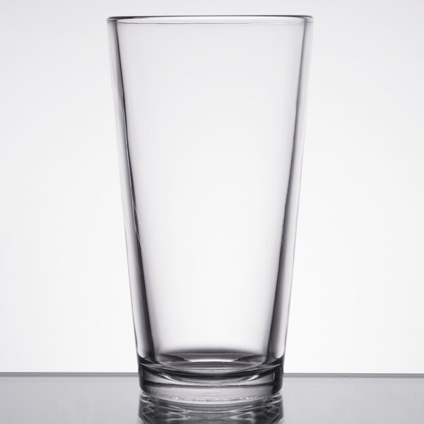 A Libbey Fizzazz tall mixing glass on a table.