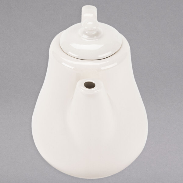 A Homer Laughlin ivory china beverage server with a lid.