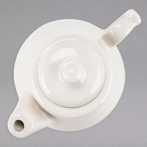 A white Homer Laughlin China beverage server with a lid.