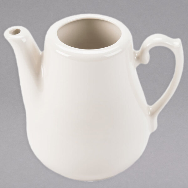 A close up of a Homer Laughlin ivory china beverage server with a lid.