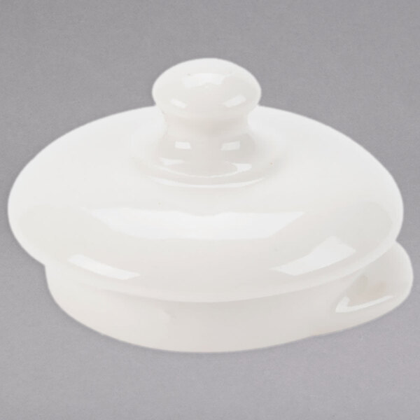 A white Homer Laughlin China beverage server with a white ceramic lid.