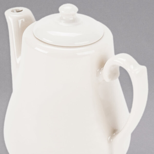 A Homer Laughlin ivory china beverage server with a lid.
