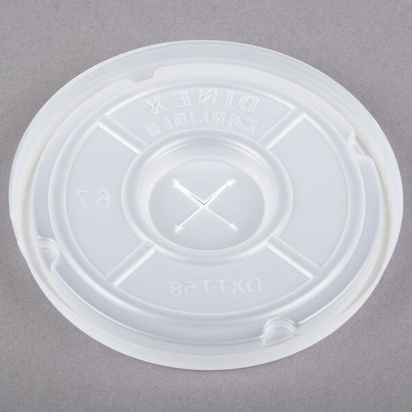 A white Dinex plastic lid with a straw slot and a cross in the center.