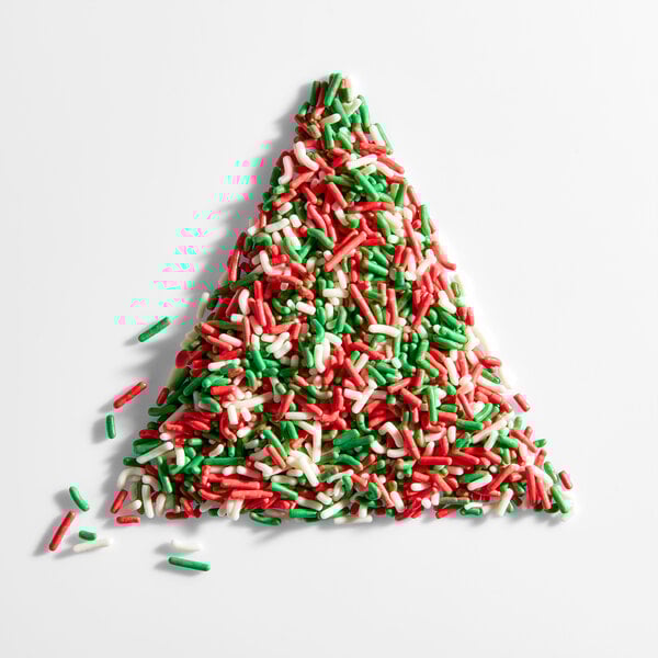 A pile of red, green, and white Christmas sprinkles arranged in a triangle shape.