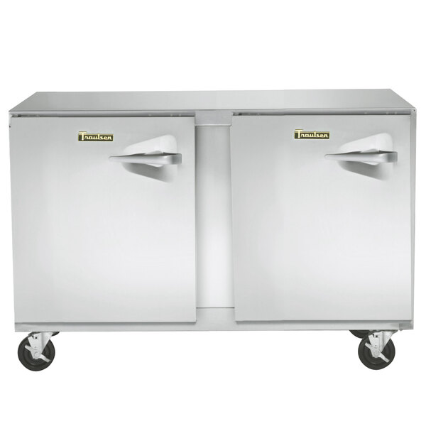 A Traulsen stainless steel undercounter freezer with two left hinged doors on wheels.