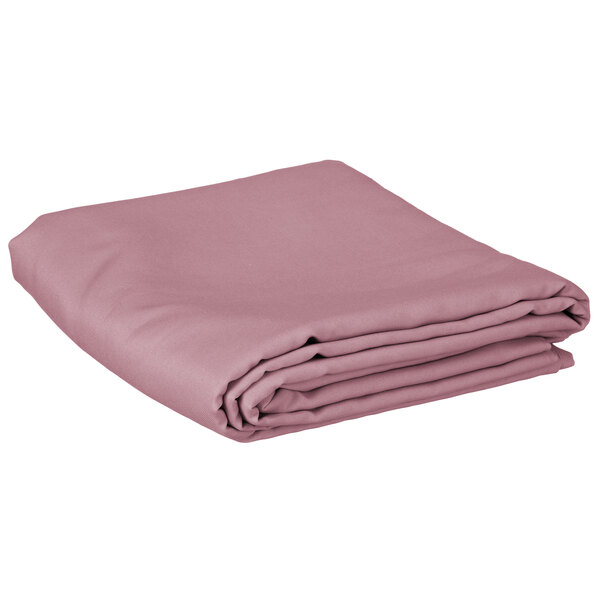A folded pink table cover on a white background.