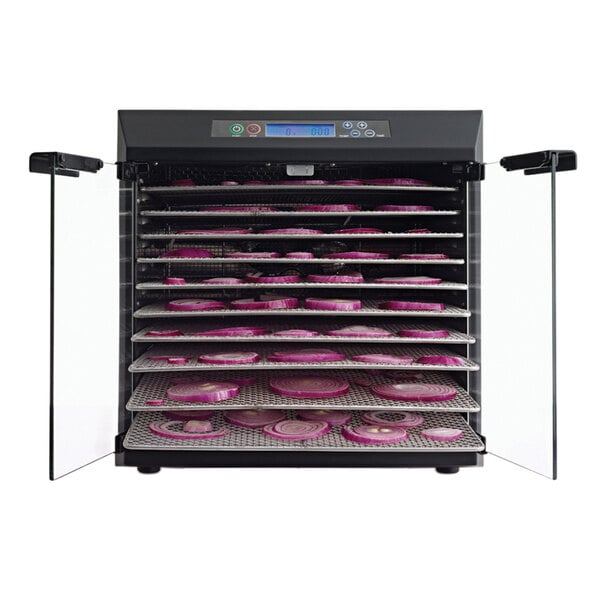 A white Excalibur food dehydrator with pink and purple vegetables on the trays.