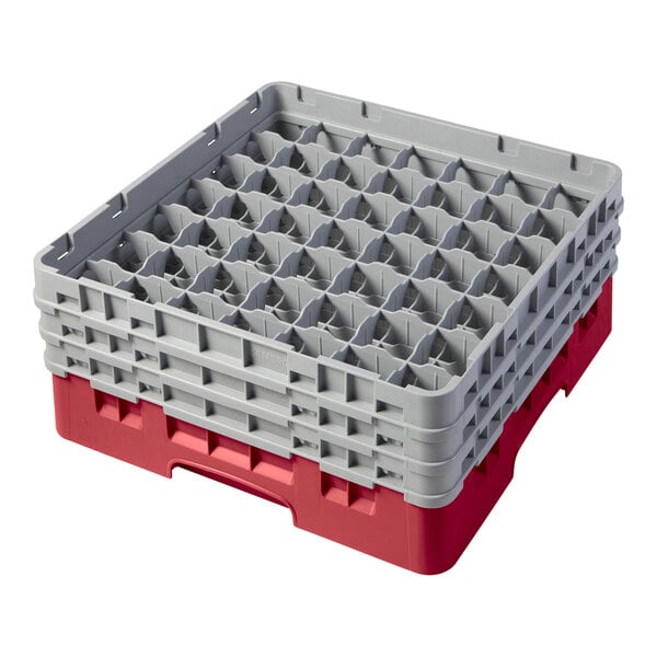 A red and gray Cambro glass rack with 49 compartments for holding glasses.