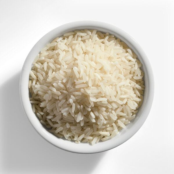 A bowl of uncooked white long grain rice.