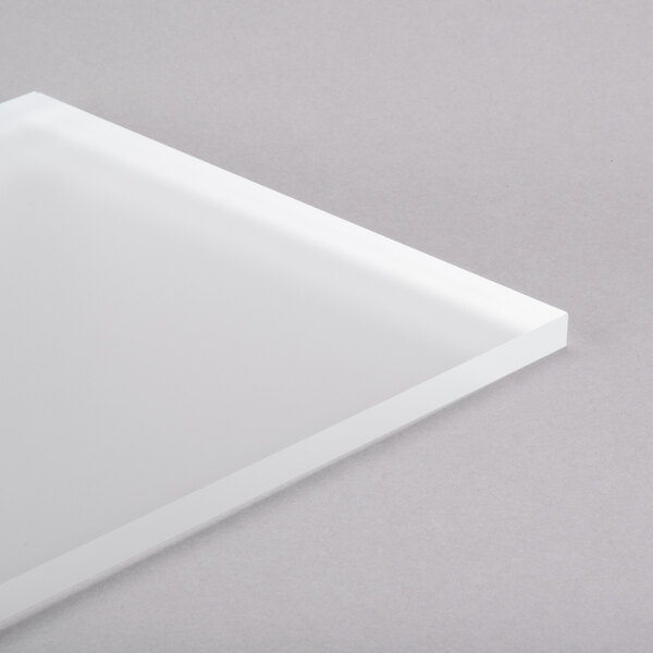 A white rectangular Eastern Tabletop tempered glass shelf on a gray surface.