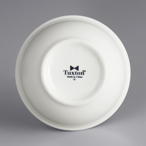 A white Tuxton china nappie bowl with black text.