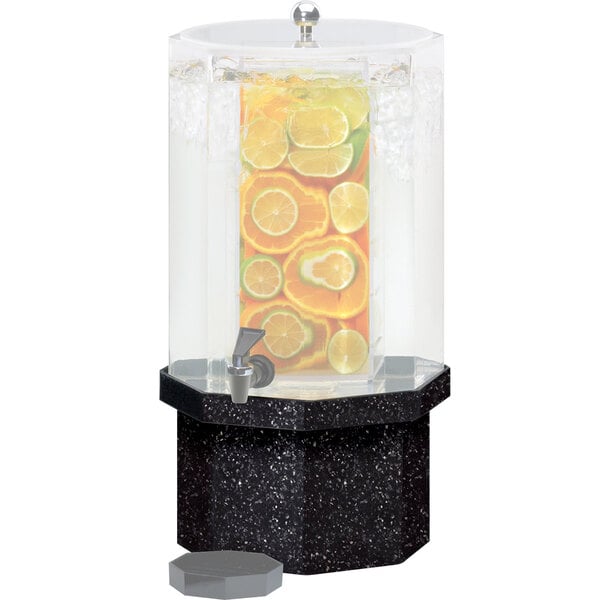 A black Cal-Mil octagonal granite charcoal base for a drink dispenser on a counter with fruit slices.