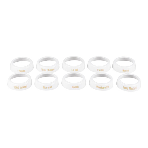 A set of ten white plastic salad dressing dispenser collars with beige lettering indicating different dressing types.