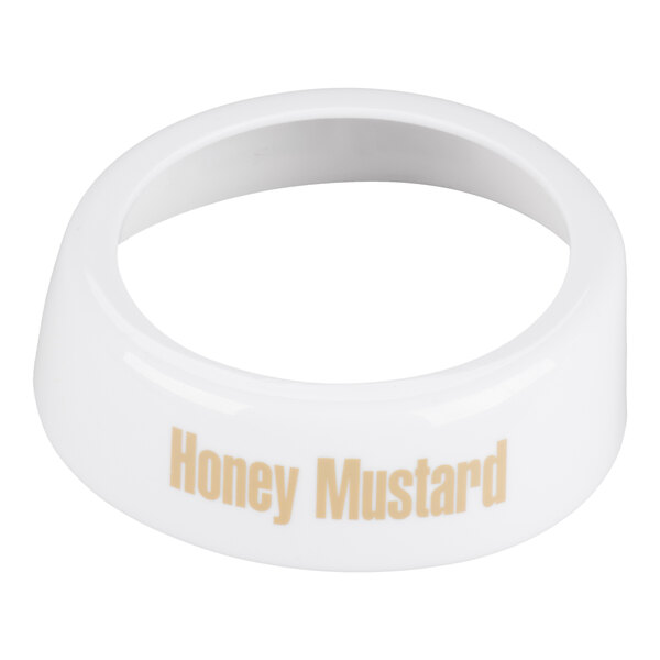 A white plastic salad dressing dispenser collar labeled 'Honey Mustard' in beige lettering.