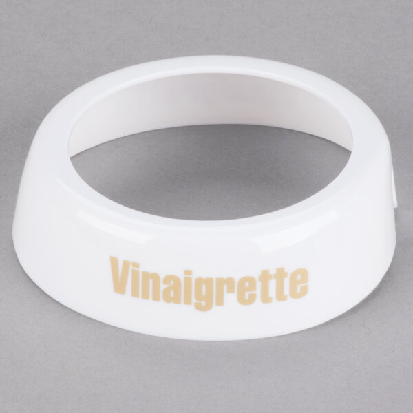 A white plastic Tablecraft salad dressing dispenser collar with beige lettering reading "Vinaigrette"