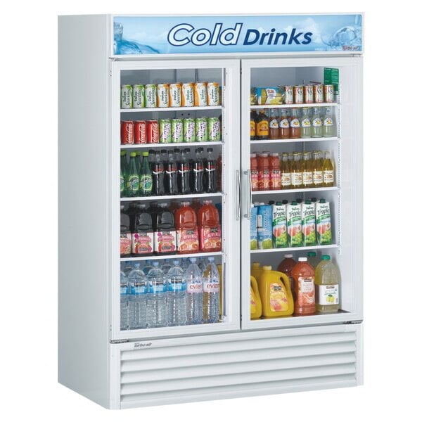 A Turbo Air white refrigerated merchandiser full of drinks with two glass doors.