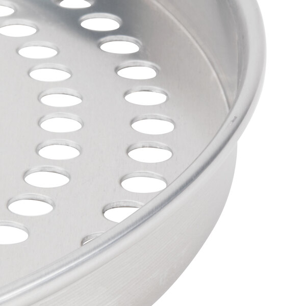 An American Metalcraft pizza pan with perforated holes in it.