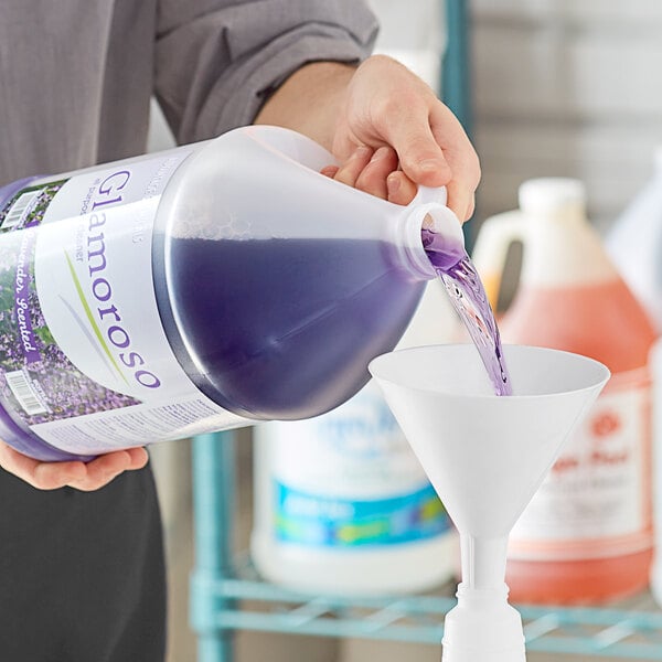 A person pouring purple Advantage Chemicals Lavender All-Purpose Cleaner into a funnel.