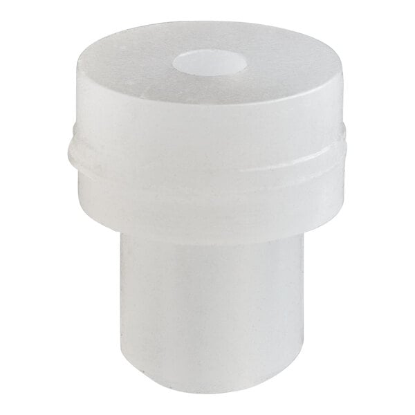 A white plastic tube with a hole.