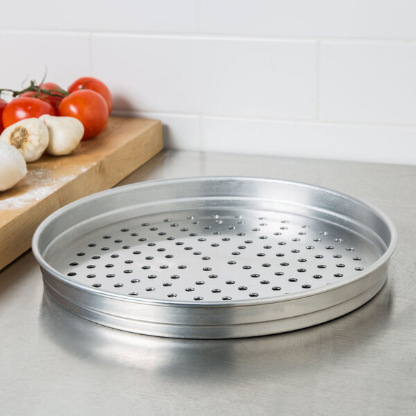 An American Metalcraft aluminum pizza pan with perforated holes.