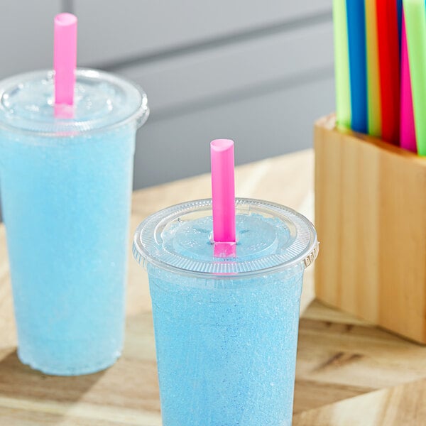 Two blue drinks with Choice neon straws on a table.