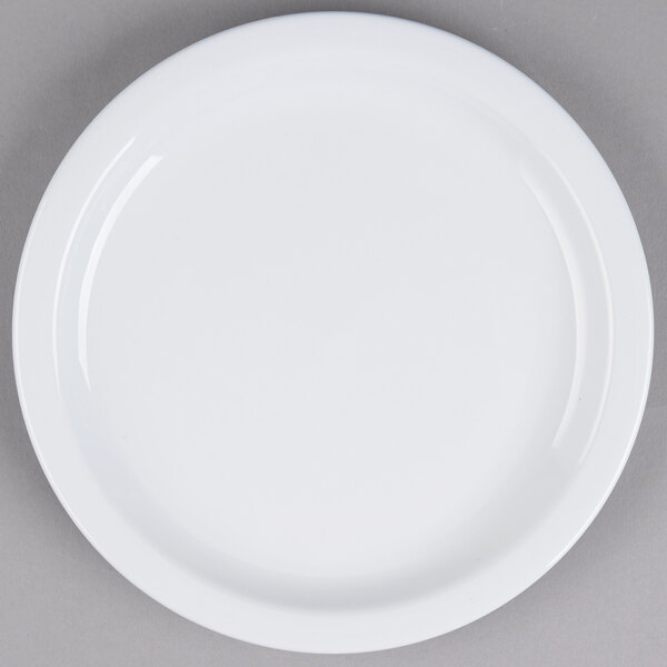 A Tuxton Colorado bright white narrow rim china plate on a gray surface.