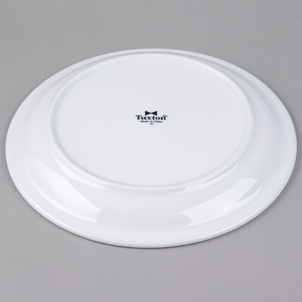 A Tuxton Colorado white china plate with a narrow black rim.