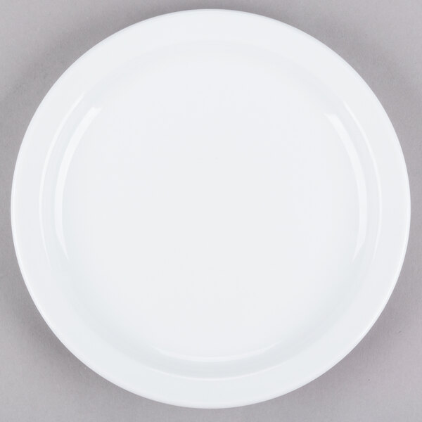 A Tuxton Colorado white china plate with a narrow white rim on a gray surface.