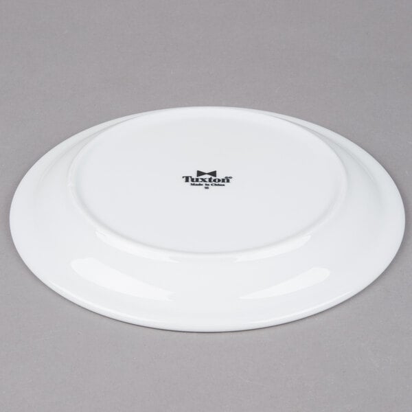 A Tuxton Colorado white china plate with a black narrow rim.