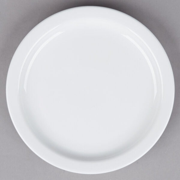 A Tuxton Colorado white plate with a narrow white rim on a gray surface.