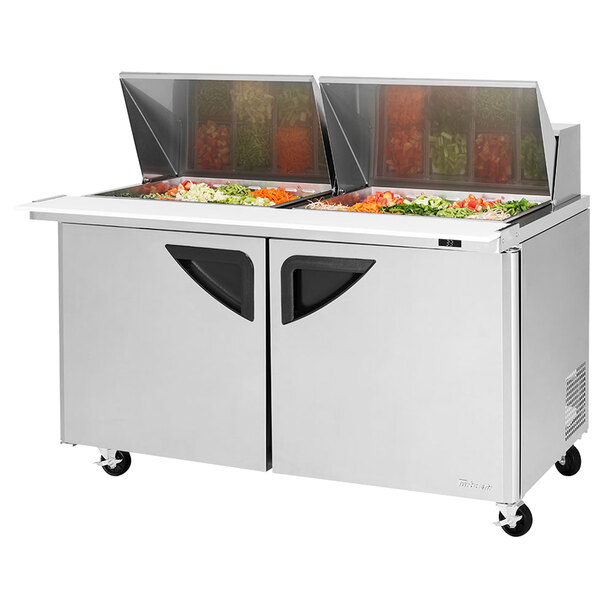 A Turbo Air sandwich prep table with two trays of food on it.
