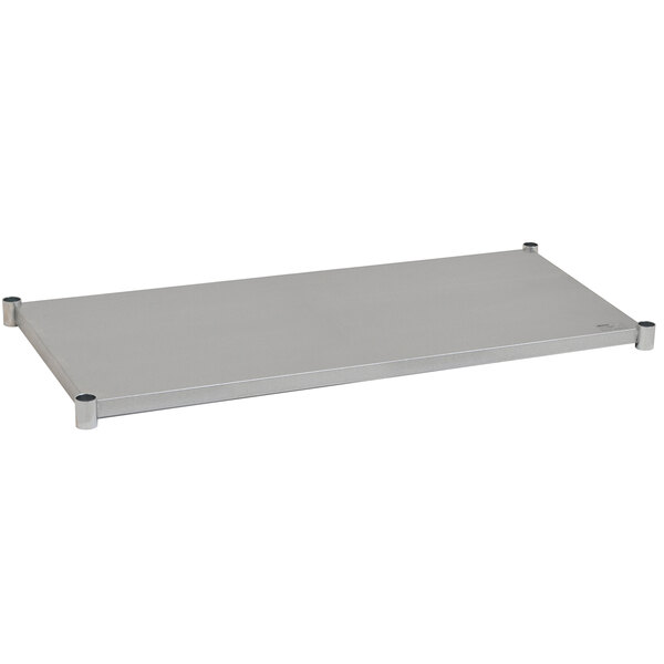 A metal shelf with metal legs designed to fit a white rectangular work table.