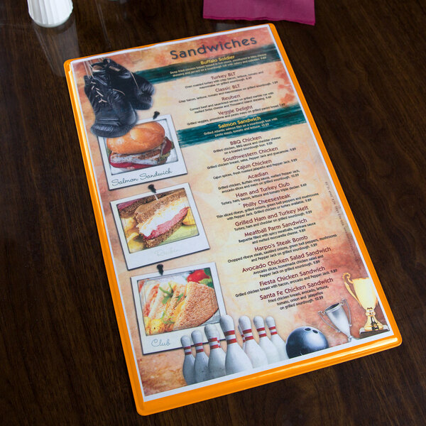 A Menu Solutions Hamilton Mandarin heat sealed menu board on a table.