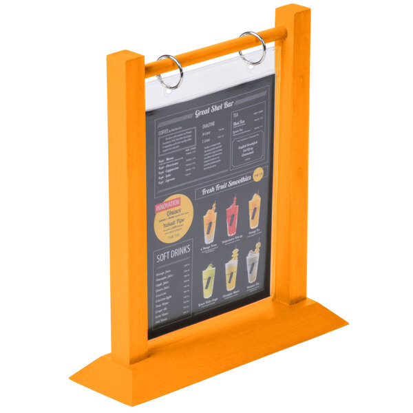 A Menu Solutions Mandarin wood flip top table tent on a table holding a menu.