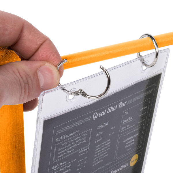 A hand holding a Menu Solutions Mandarin wood flip top menu card.