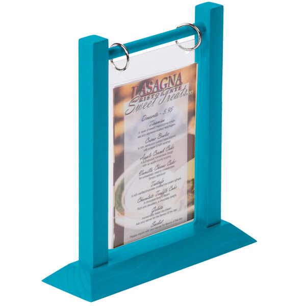 A sky blue wood flip top table tent with a menu inside.