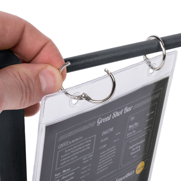 A hand holding a Menu Solutions ash wood table tent.