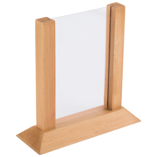 A close-up of a wooden frame with white paper inside.