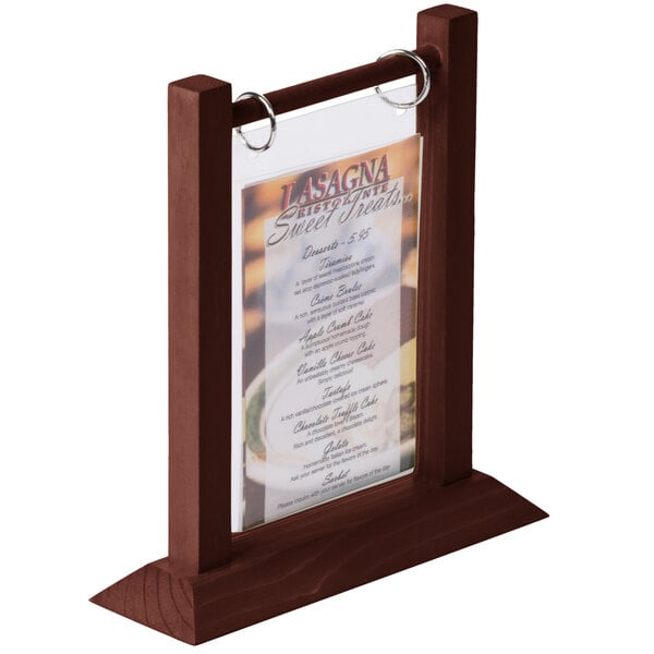A Menu Solutions mahogany wood flip top table tent holding a menu on a table.