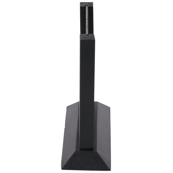 A black rectangular Menu Solutions table sign board with a black wood base.