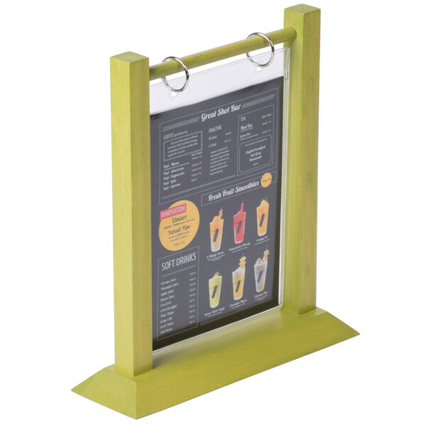 A Menu Solutions lime wood flip top table tent on a table.