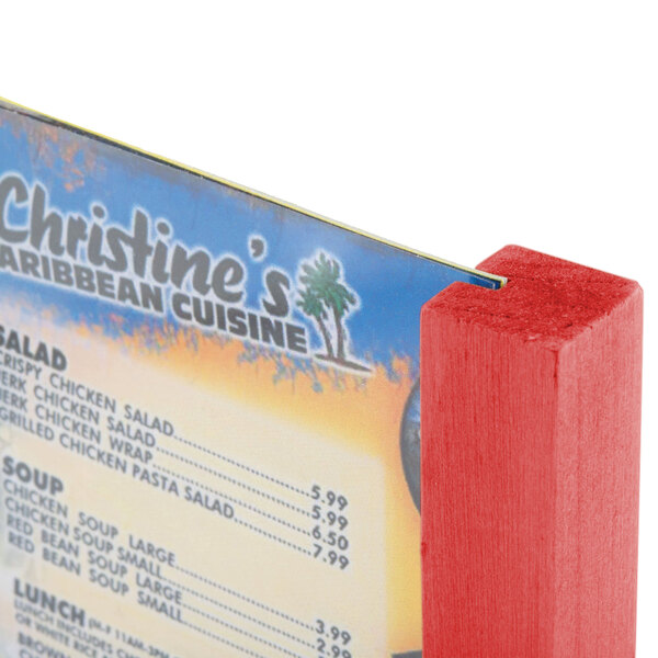 A red wooden Menu Solutions table tent on a table.