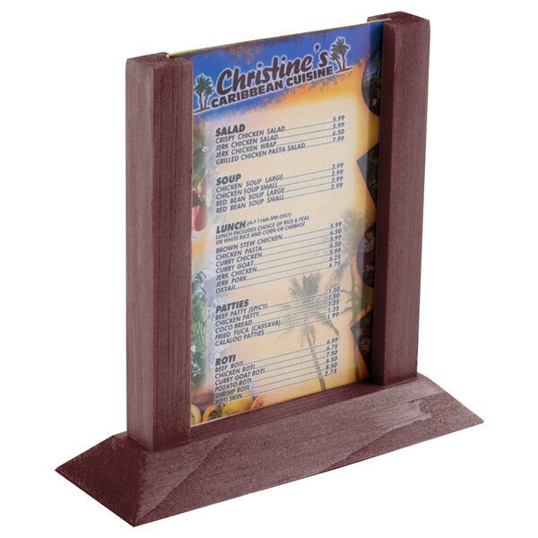 A mahogany wood table tent with a menu in it.