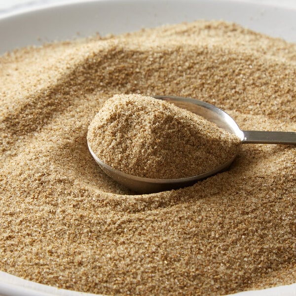 A spoon with brown celery salt in a bowl.