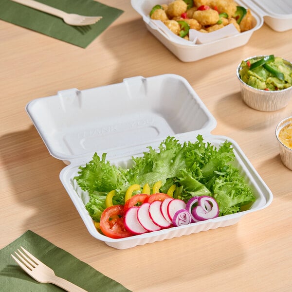 A white compostable plant fiber take-out container with a single compartment, shown holding a fresh salad.